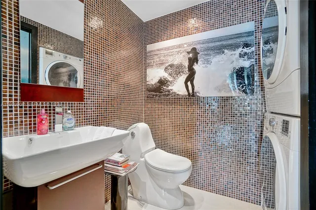 a bathroom with a toilet sink and mirror