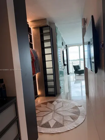 a view of entryway and hall with wooden floor