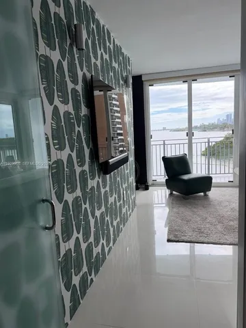 a bedroom with a bed and glass windows