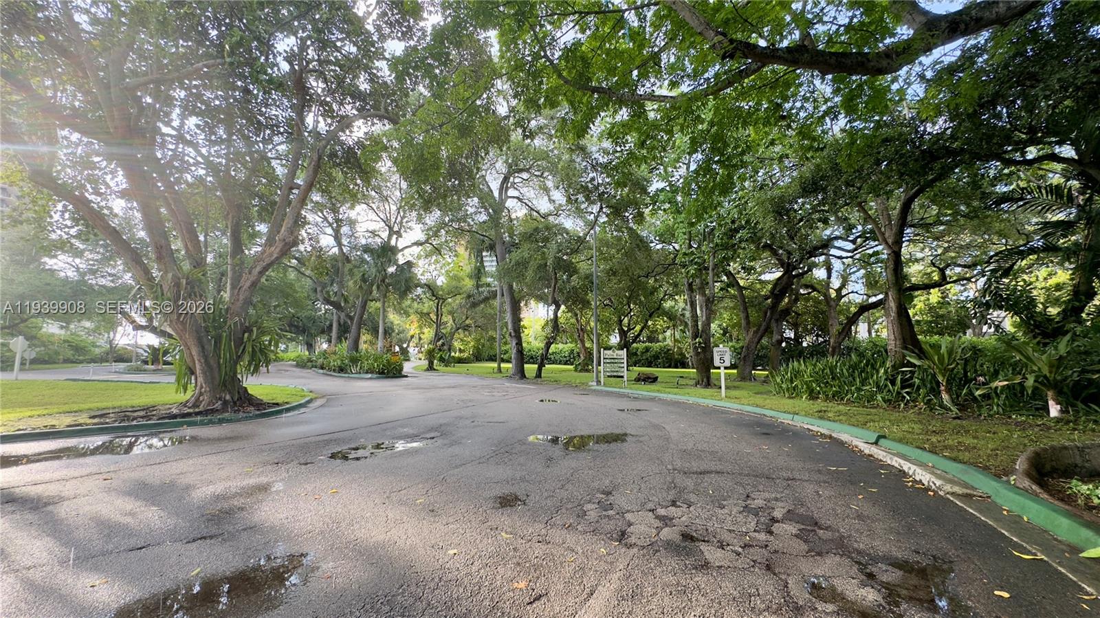 770 Northeast 69th Street, Unit 6F Miami, FL 33138 - Photo 24 of 47 a view of a road with a yard