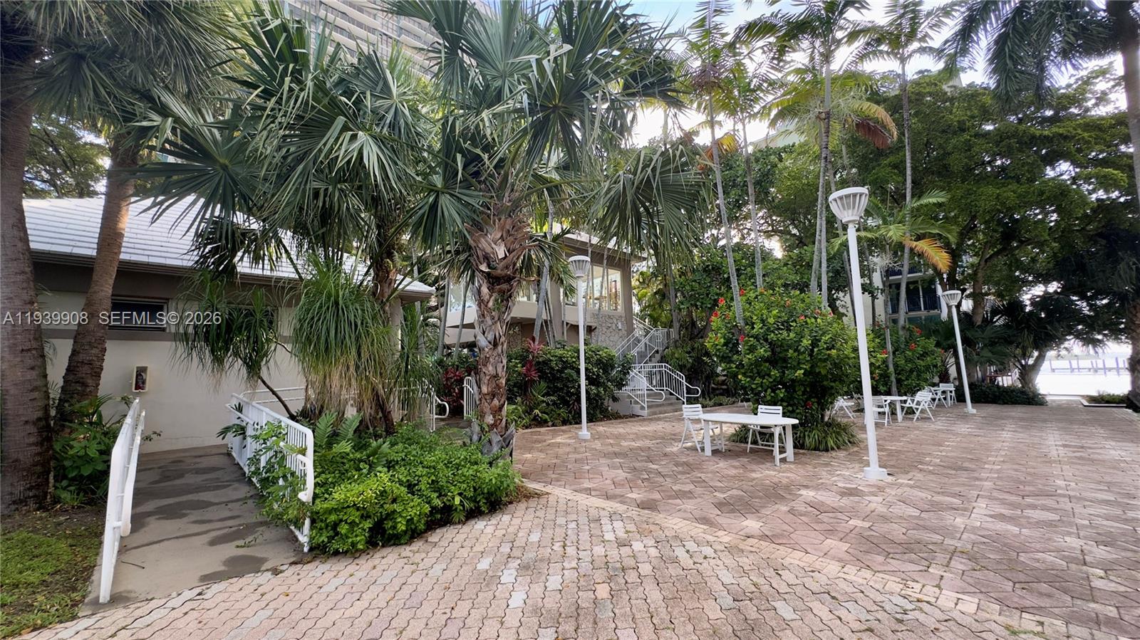 770 Northeast 69th Street, Unit 6F Miami, FL 33138 - Photo 34 of 47 a view of outdoor space with seating area and trees