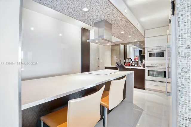 a kitchen with stainless steel appliances a refrigerator and a stove