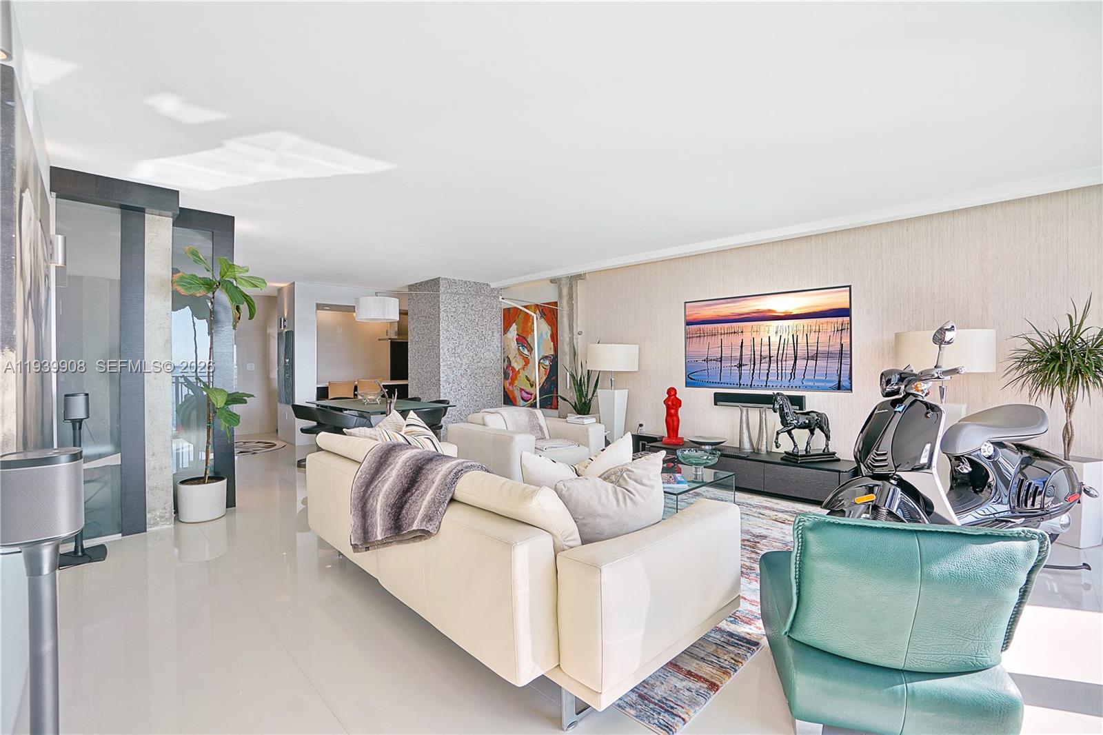 770 Northeast 69th Street, Unit 6F Miami, FL 33138 - Photo 10 of 47 a living room with furniture and a flat screen tv