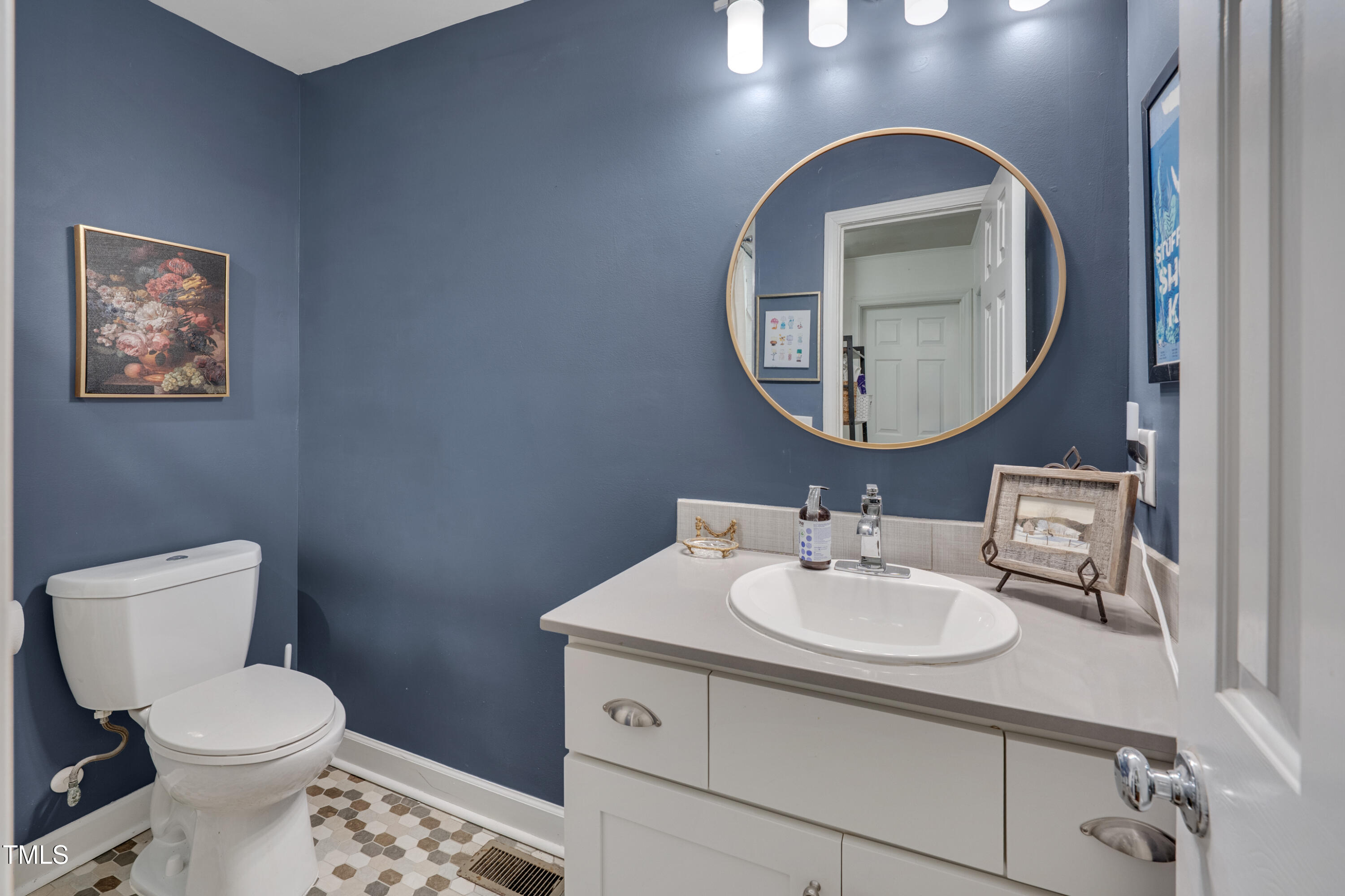 2442 Stevens Road Raleigh, NC 27610 - Photo 15 of 22 a bathroom with a toilet sink and mirror