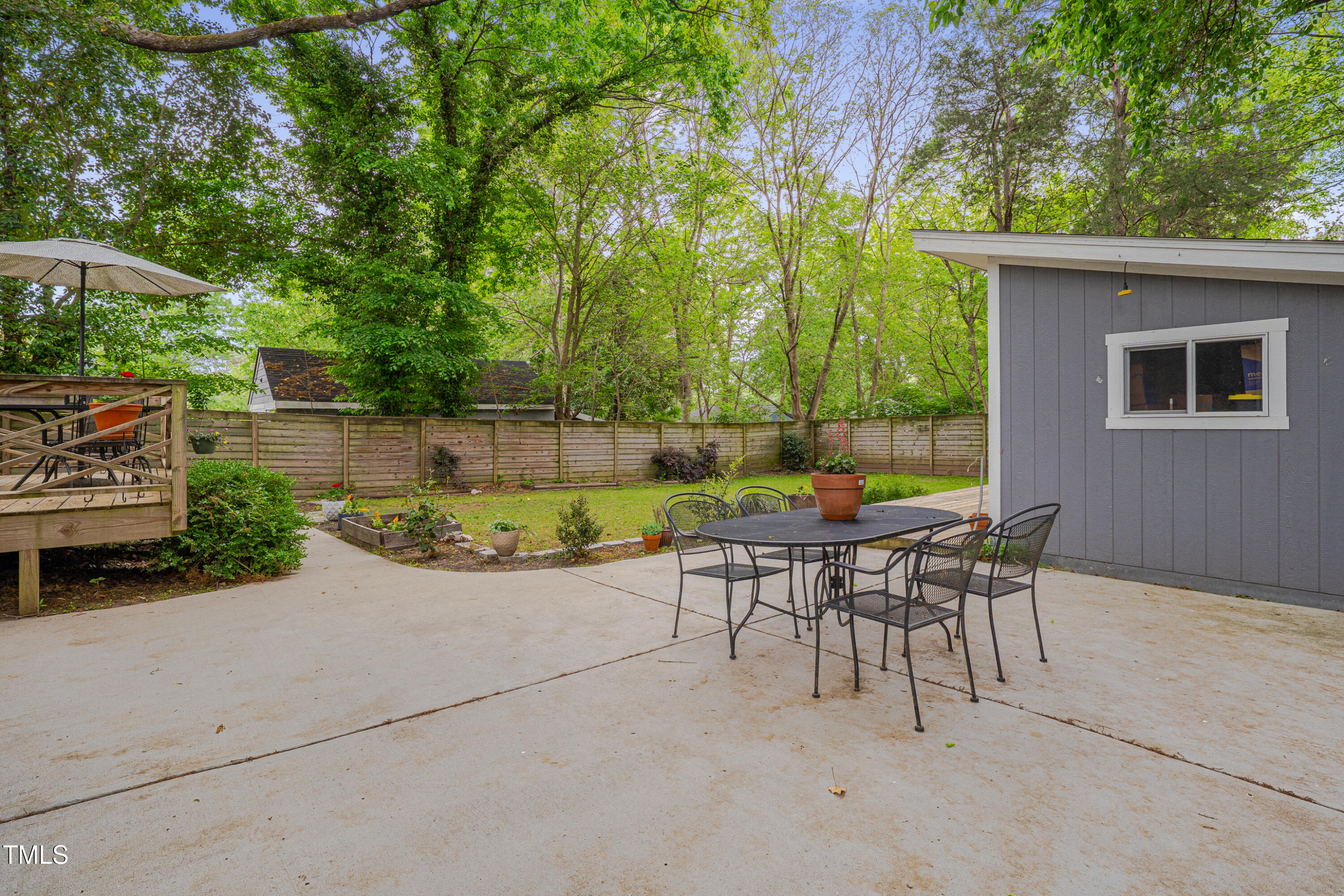 2442 Stevens Road Raleigh, NC 27610 - Photo 21 of 22 a view of a patio with table and chairs and potted plants