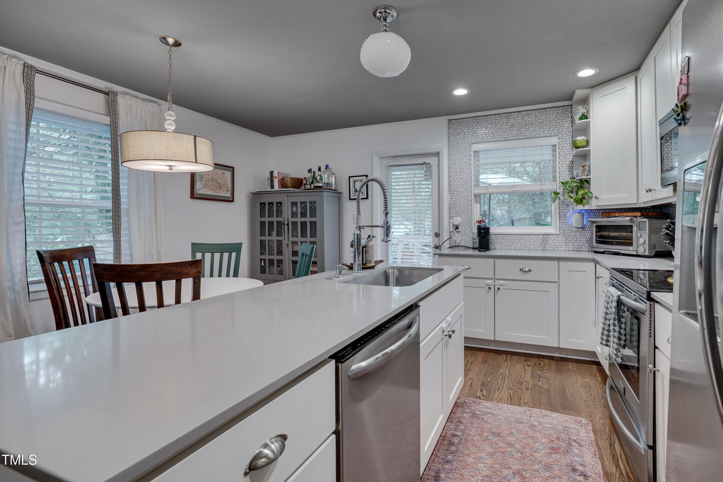 2442 Stevens Road Raleigh, NC 27610 - Photo 8 of 22 a kitchen that has a lot of cabinets a sink and a stove