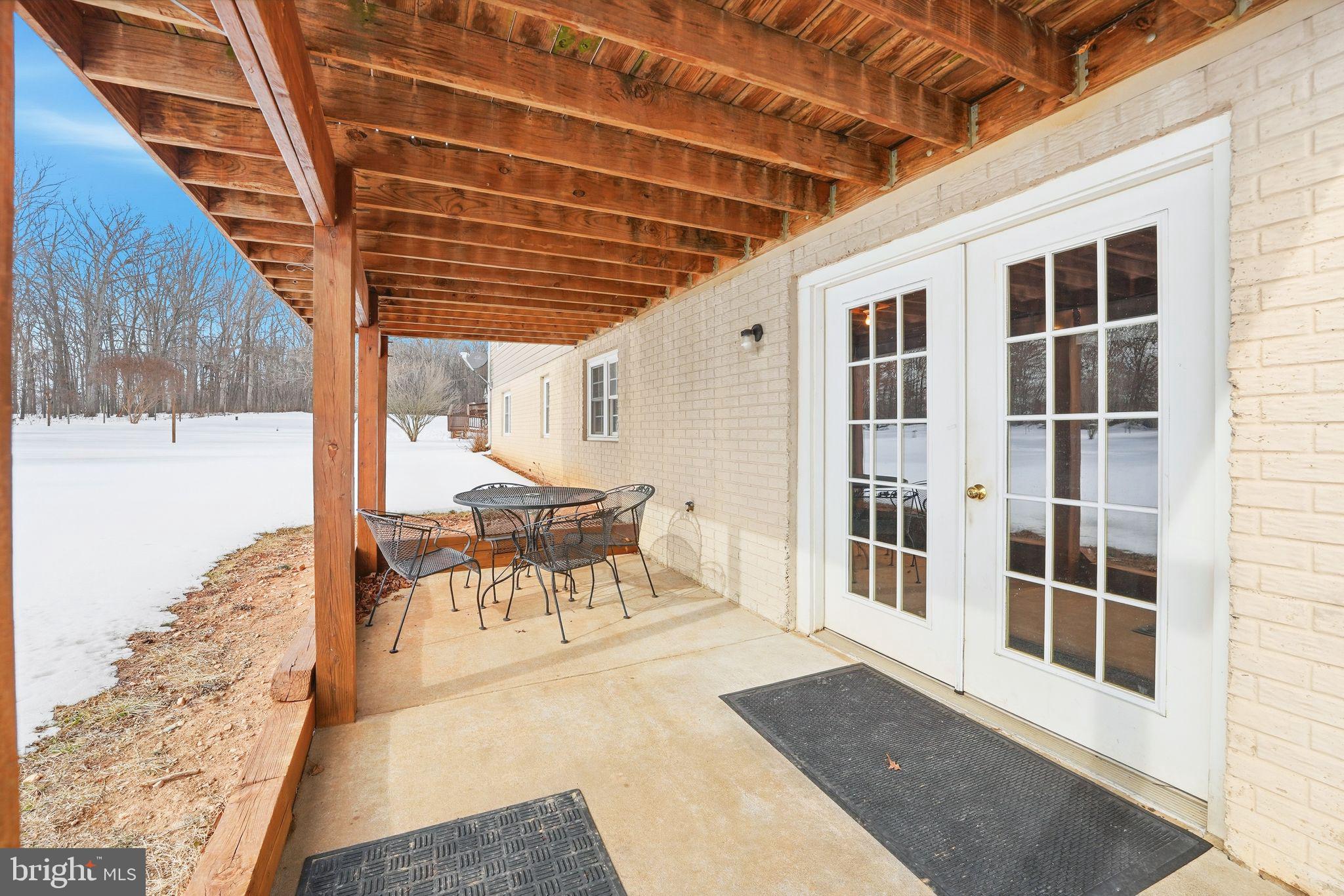 16355 Pollard Lane Culpeper, VA 22701 - Photo 11 of 56 a porch with a table and chairs