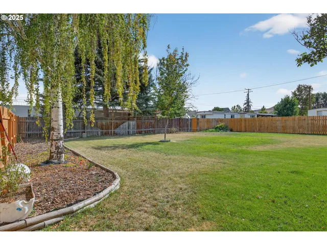 a view of a house with a wooden fence
