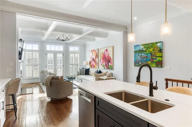 a kitchen with a sink a counter space and living room