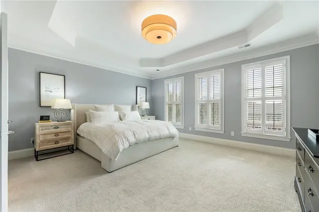 a spacious bedroom with a bed and a large window