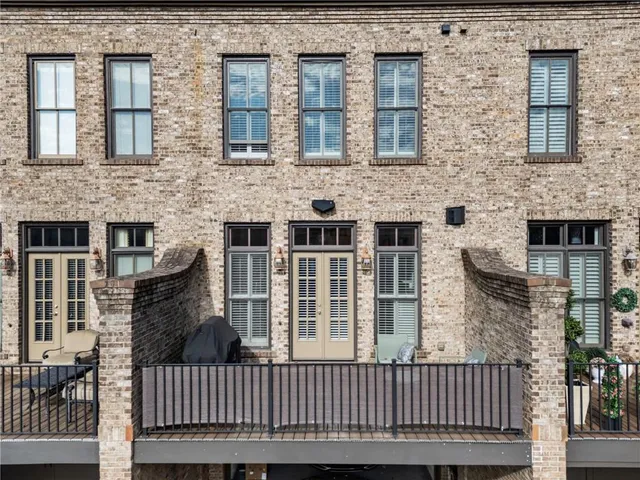 a view of a brick house with large windows