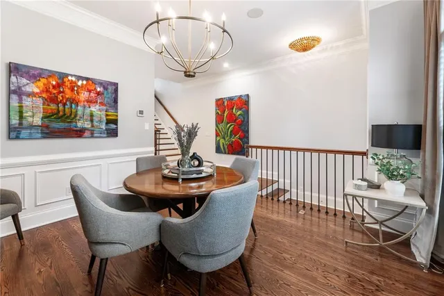 a dining room with furniture a chandelier and wooden floor