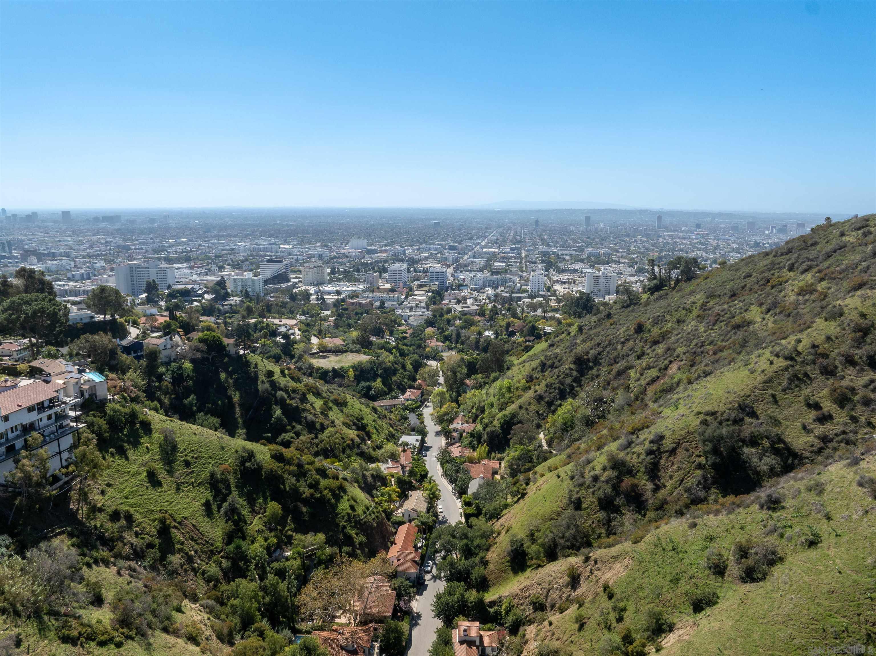 an aerial view of house with yard and mountain view in back