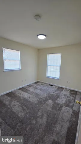 an empty room with a empty space and windows