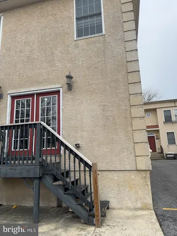 a view of balcony with two chairs and wooden floor