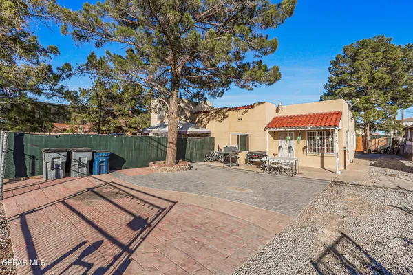 a view of a white house with a big yard and large trees