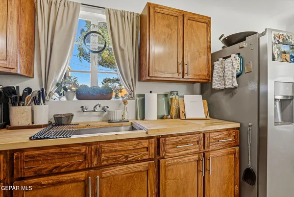 a kitchen with stainless steel appliances granite countertop a sink and a refrigerator