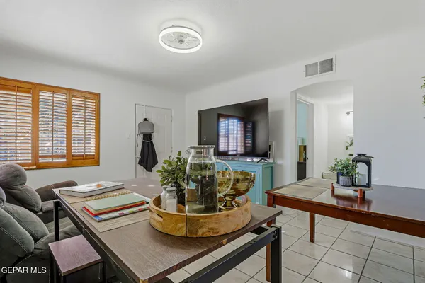 a living room with furniture and a potted plant