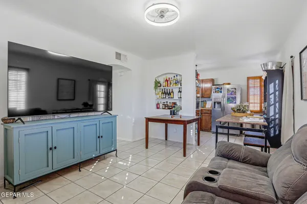 a living room with furniture a rug and white walls
