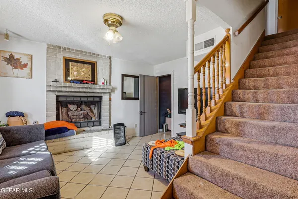 a view of a livingroom with furniture and staircase