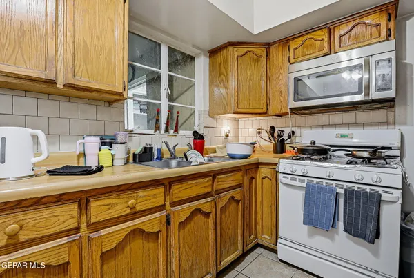 a kitchen with stainless steel appliances granite countertop a sink and cabinets