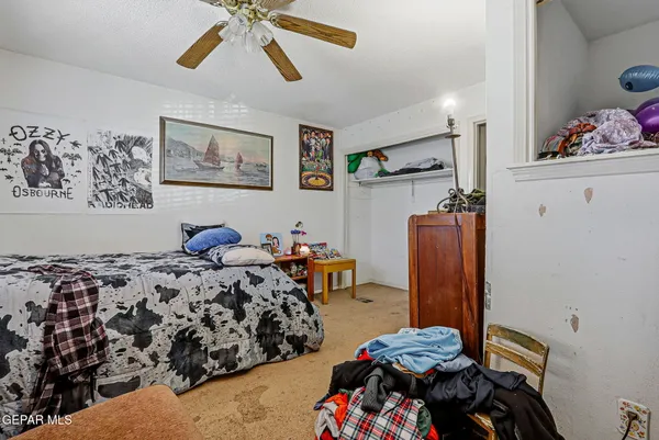 a bedroom with furniture and a window