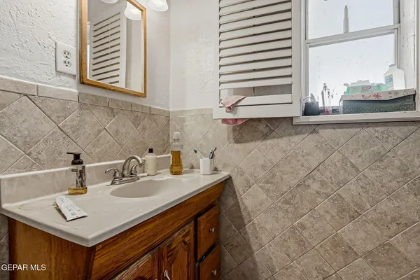 a bedroom with a bed and large windows