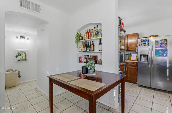 a view of kitchen with furniture and stainless steel appliances