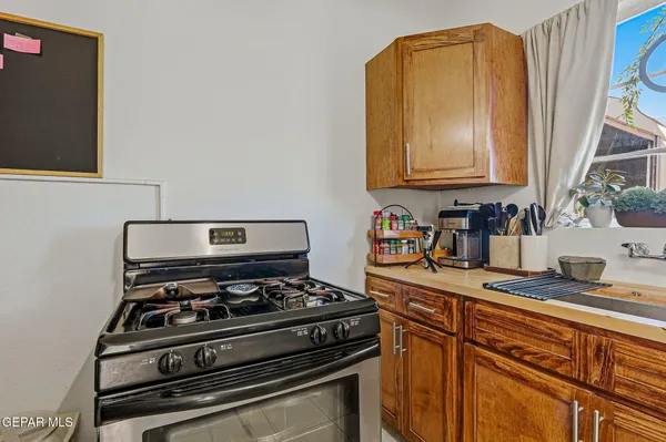 a kitchen with stainless steel appliances granite countertop a stove and a microwave