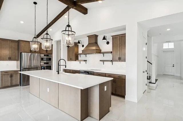a view of kitchen with stainless steel appliances cabinets and wooden floor