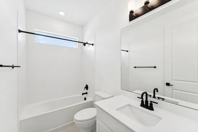 a white toilet sitting next to a window