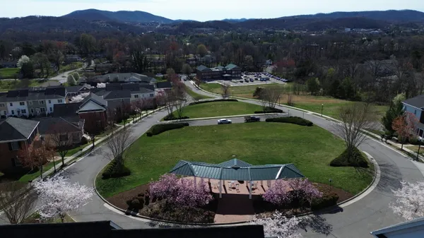 an aerial view of a house with garden space and street view