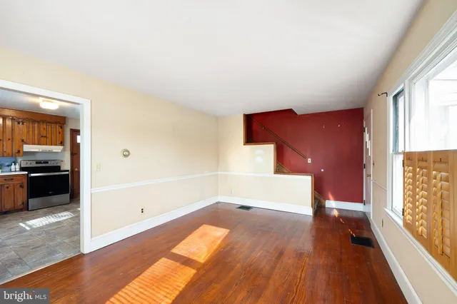 wooden floor in an empty room with a window