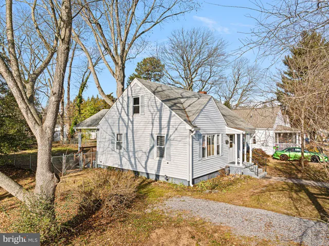 a view of a white house that has a tree in it