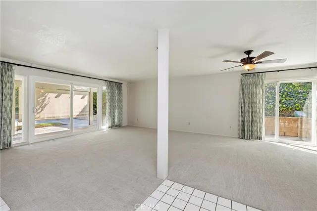 a view of an empty room with a fireplace