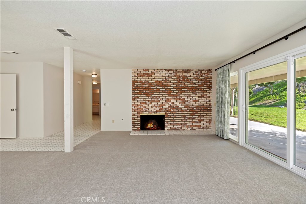 1440 Trenton Drive Riverside, CA 92506 - Photo 13 of 52 a view of a livingroom with an empty space and a fireplace
