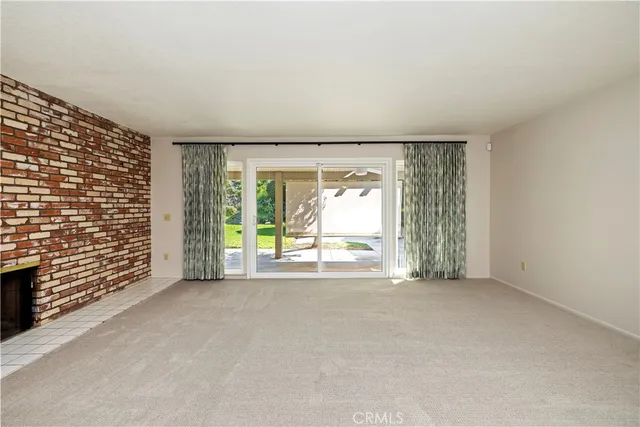 an empty room with wooden floor and ceiling fan
