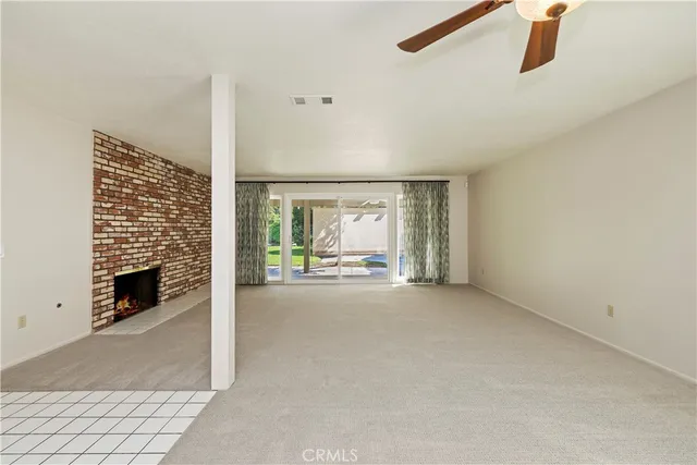 a view of a livingroom with a ceiling fan and window
