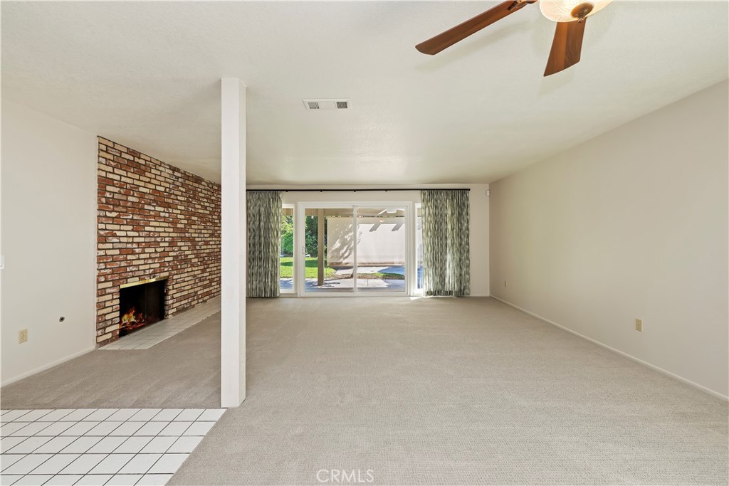 1440 Trenton Drive Riverside, CA 92506 - Photo 16 of 52 a view of an empty room with fireplace and a window