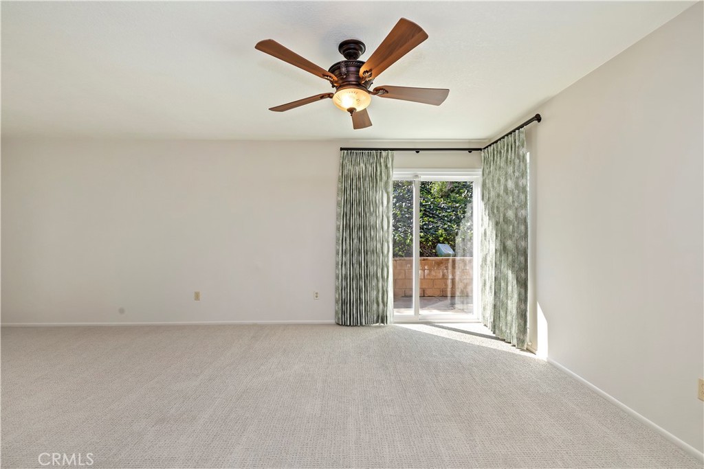 1440 Trenton Drive Riverside, CA 92506 - Photo 17 of 52 an empty room with wooden floor and ceiling fan