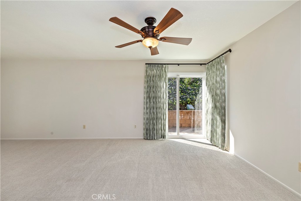 1440 Trenton Drive Riverside, CA 92506 - Photo 21 of 52 an empty room with wooden floor and ceiling fan