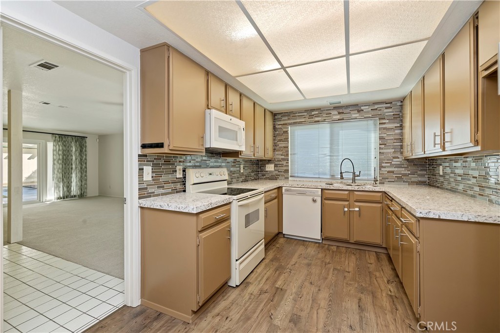 1440 Trenton Drive Riverside, CA 92506 - Photo 22 of 52 a kitchen with stainless steel appliances granite countertop a stove a sink and a refrigerator