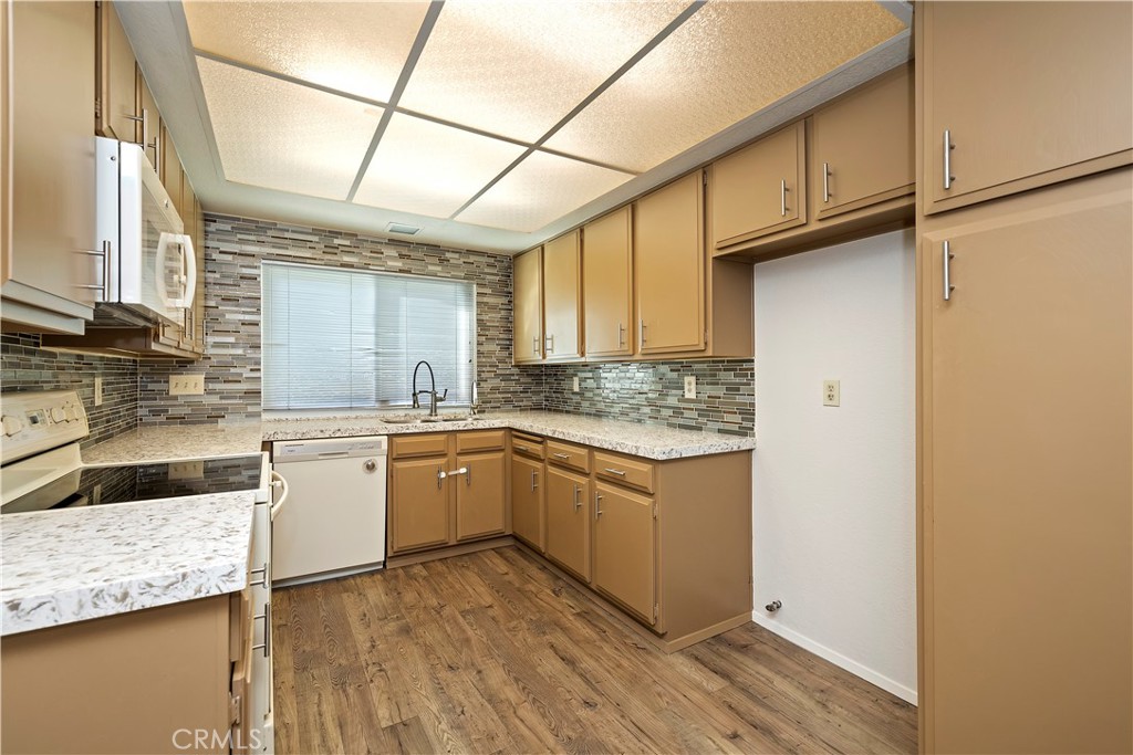 1440 Trenton Drive Riverside, CA 92506 - Photo 23 of 52 a kitchen with granite countertop cabinets stainless steel appliances and a counter space