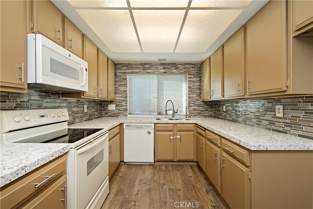 1440 Trenton Drive Riverside, CA 92506 - Photo 24 of 52 a kitchen with a sink stove and cabinets