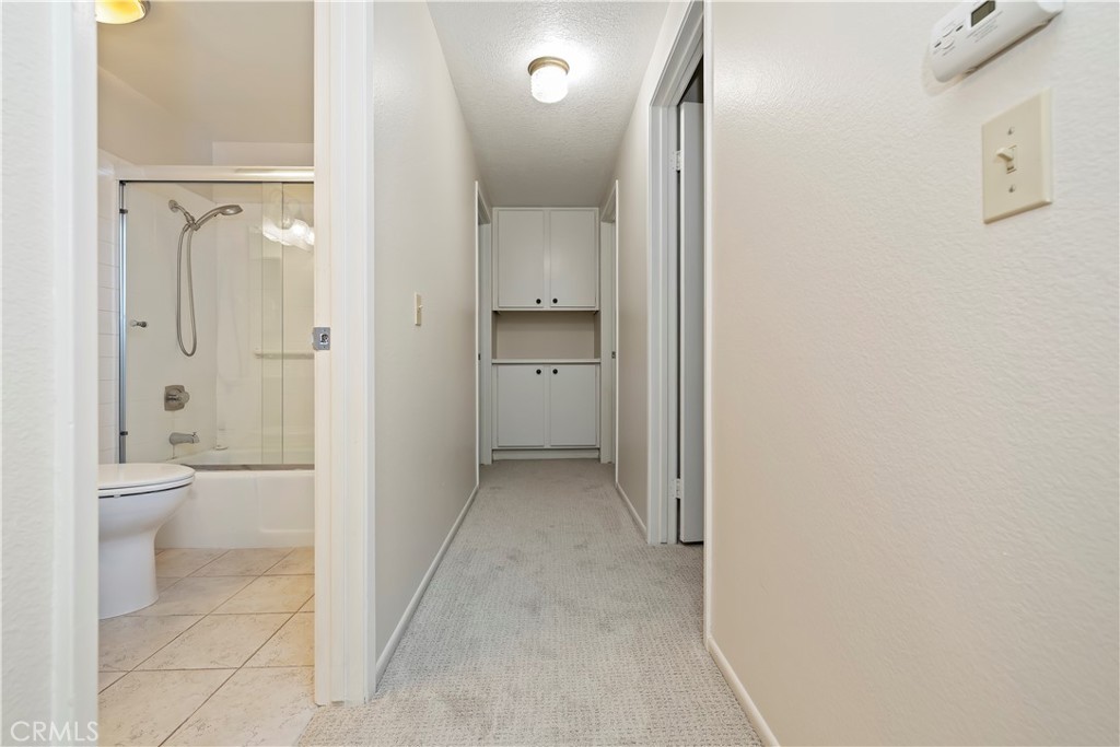 1440 Trenton Drive Riverside, CA 92506 - Photo 30 of 52 a bathroom with a granite countertop toilet a sink and a mirror