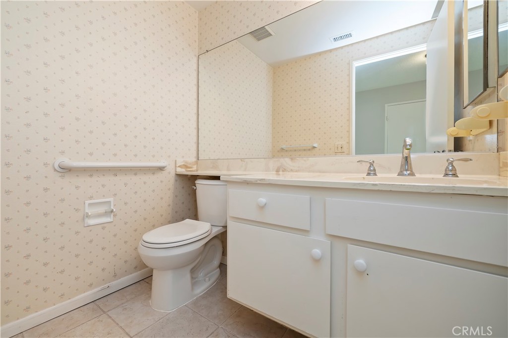 1440 Trenton Drive Riverside, CA 92506 - Photo 31 of 52 a bathroom with a sink toilet and mirror