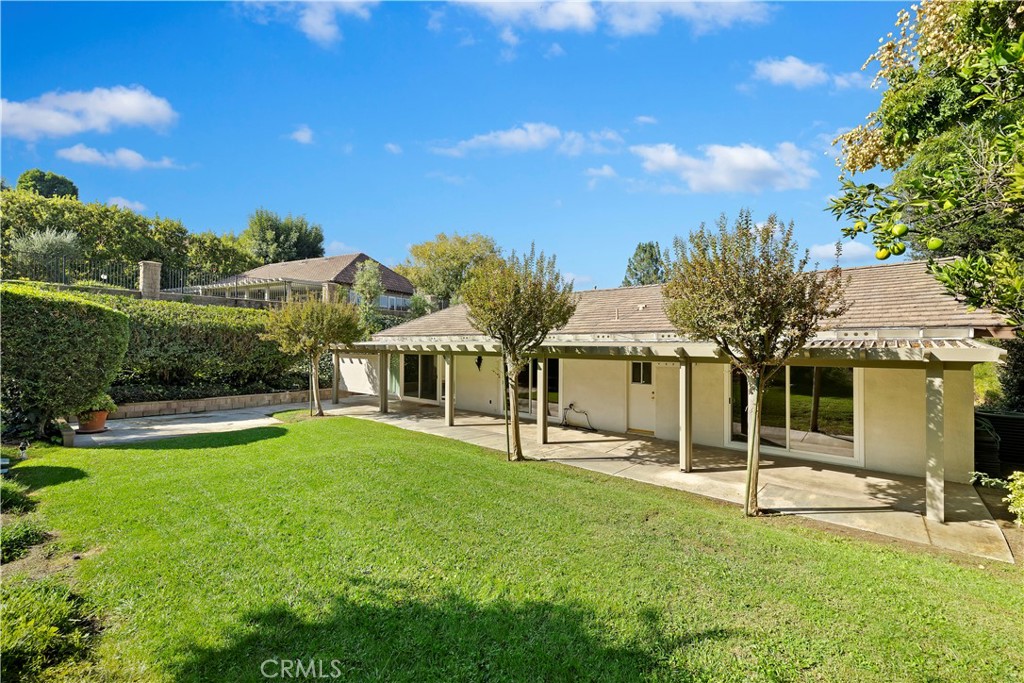 1440 Trenton Drive Riverside, CA 92506 - Photo 40 of 52 a view of a house with swimming pool and a yard