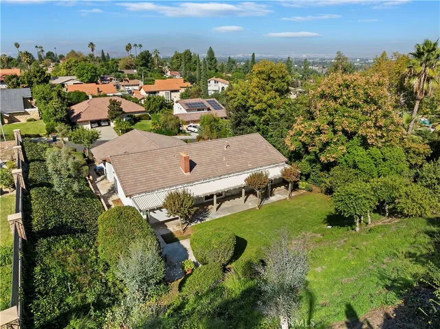 an aerial view of a house with a yard and garden