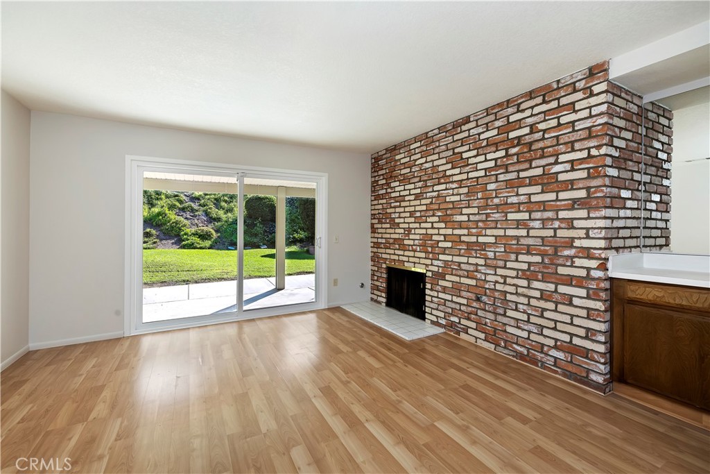 1440 Trenton Drive Riverside, CA 92506 - Photo 10 of 52 a view of empty room with wooden floor and fireplace