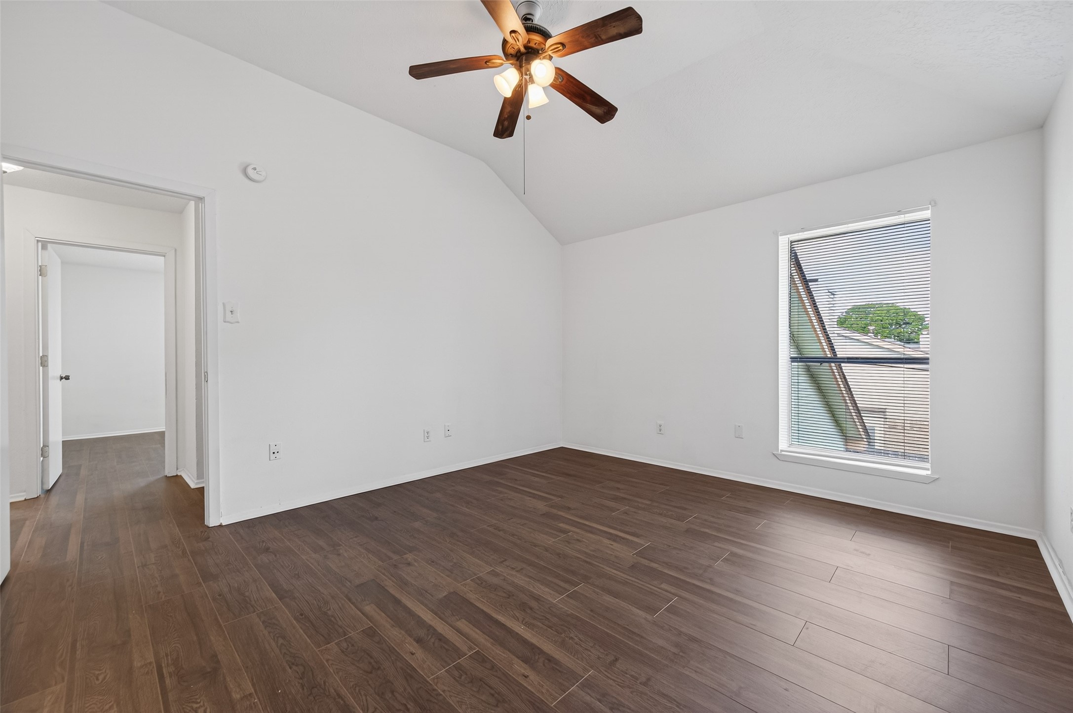 11718 Inga Lane Houston, TX 77064 - Photo 12 of 24 an empty room with wooden floor a ceiling fan and windows